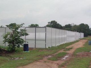 A white color net house used on a commercial cultivation land of CIC Okra seeds